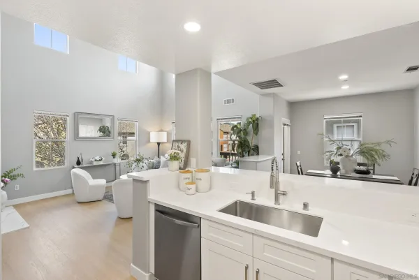 a kitchen with sink a stove and cabinets