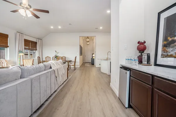 a living room with furniture and wooden floor