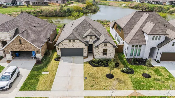 an aerial view of a house with swimming pool and garden