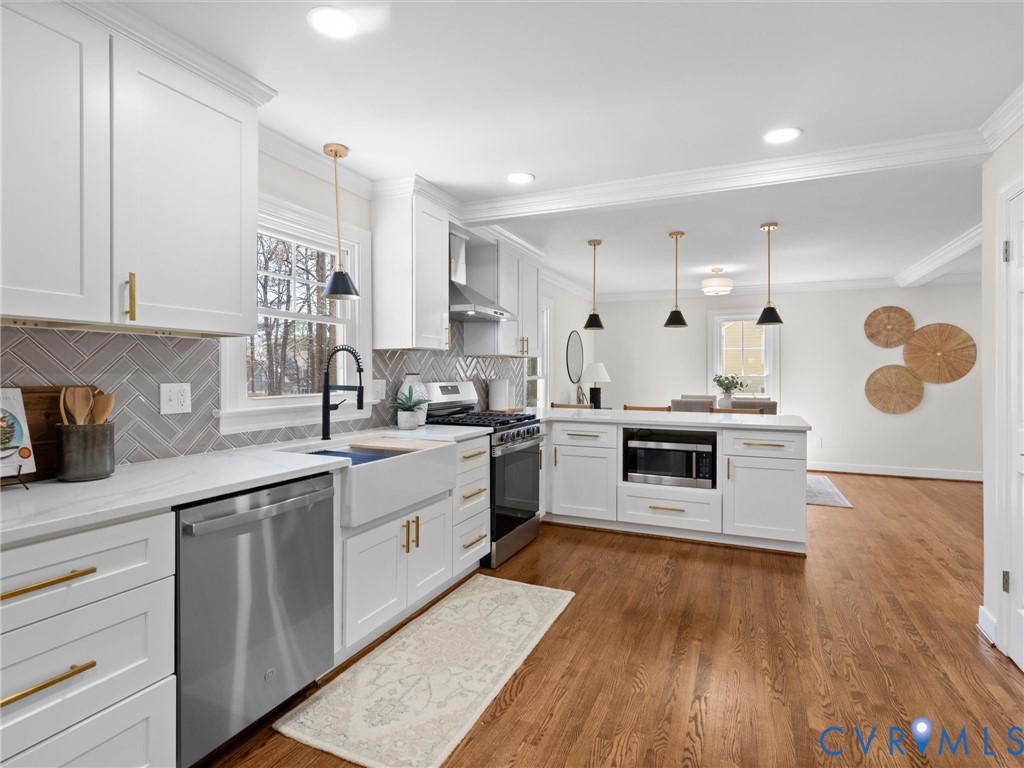 2501 Wildercroft Road Midlothian, VA 23113 - Photo 22 of 79 a kitchen with stainless steel appliances granite countertop a sink a stove and a wooden floors