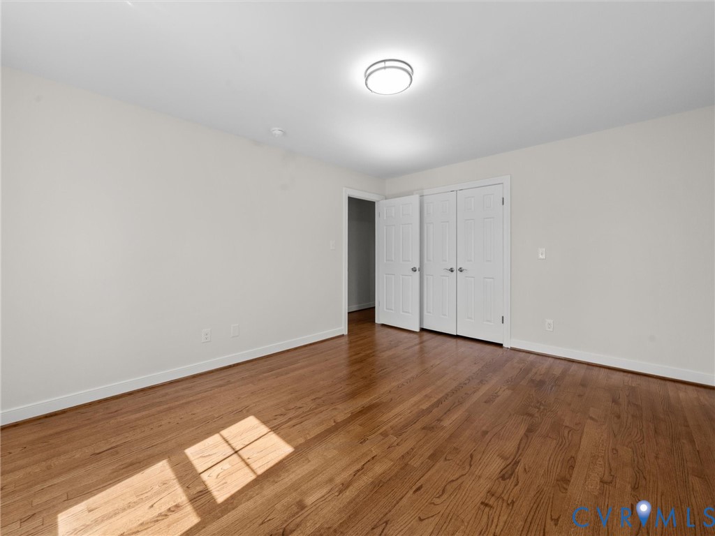 2501 Wildercroft Road Midlothian, VA 23113 - Photo 46 of 79 a view of an empty room with wooden floor and a window