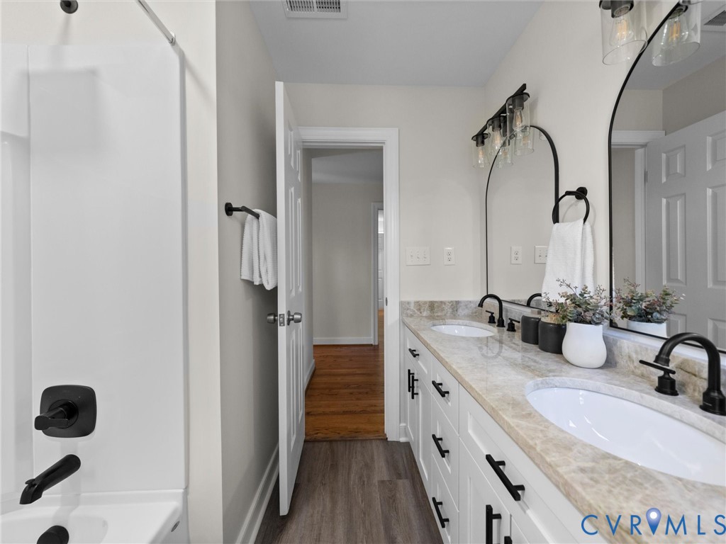 2501 Wildercroft Road Midlothian, VA 23113 - Photo 49 of 79 a bathroom with a granite countertop double vanity sink a mirror and shower
