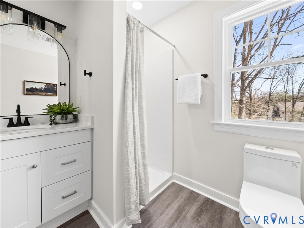 2501 Wildercroft Road Midlothian, VA 23113 - Photo 62 of 79 a bathroom with a toilet a sink and a window