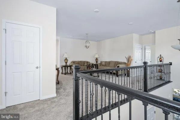 a bedroom with a bed and a flat tv screen on a dresser