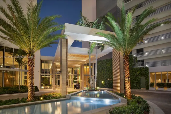 a palm tree sitting in front of a building