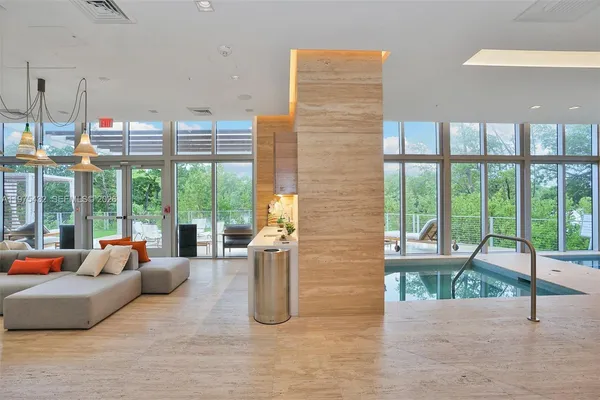 a living room with furniture and a chandelier