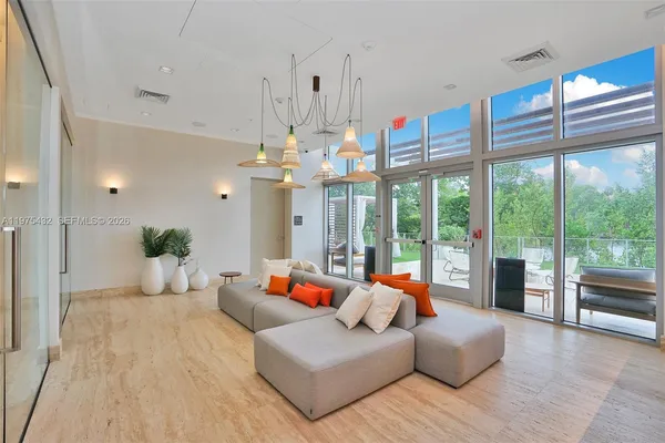 a living room with furniture and a chandelier