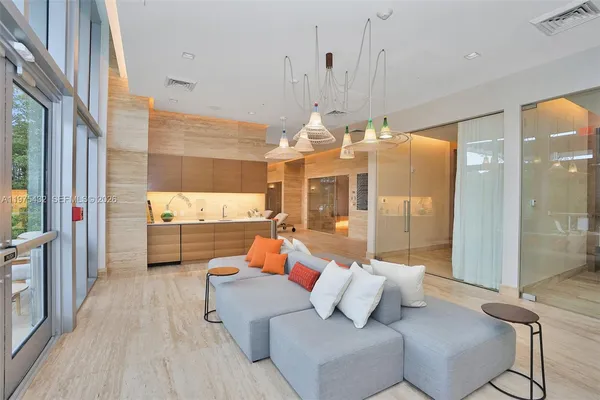 a living room with furniture and a floor to ceiling window