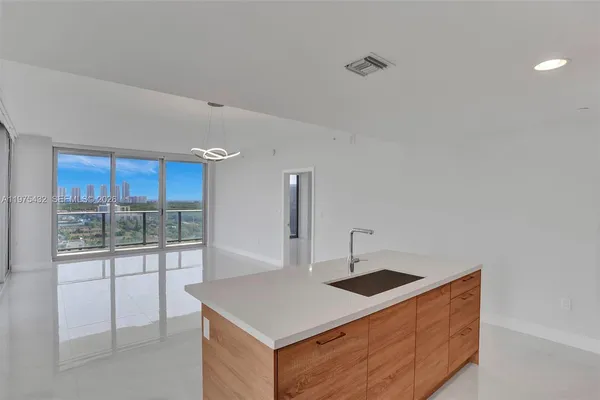 a kitchen that has a sink and a stove in it