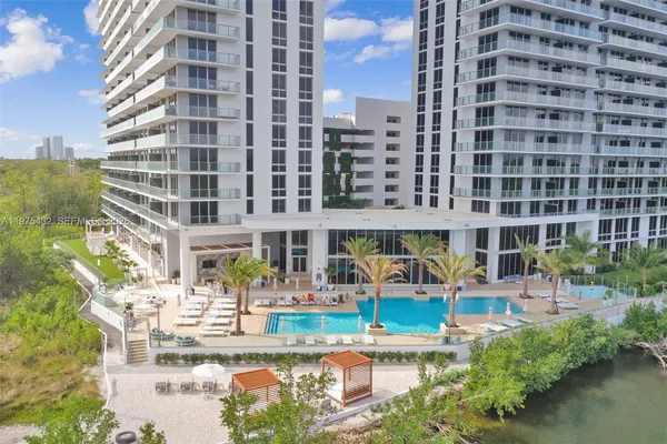 a view of a swimming pool with outdoor seating