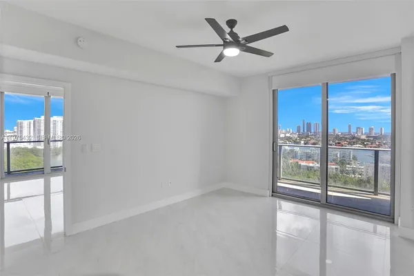 a view of a livingroom with a ceiling fan and window