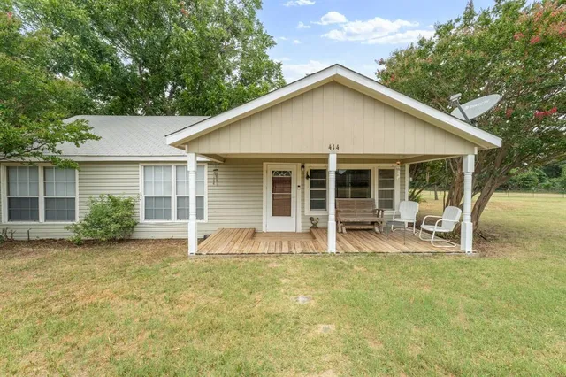 a front view of house with yard and seating space