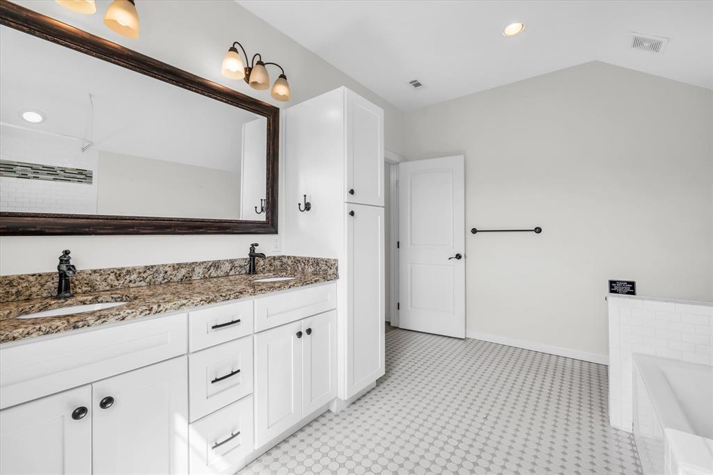 348 Barker Lane Waco, TX 76705 - Photo 20 of 39 a en suite bathroom with a granite countertop sink and a mirror