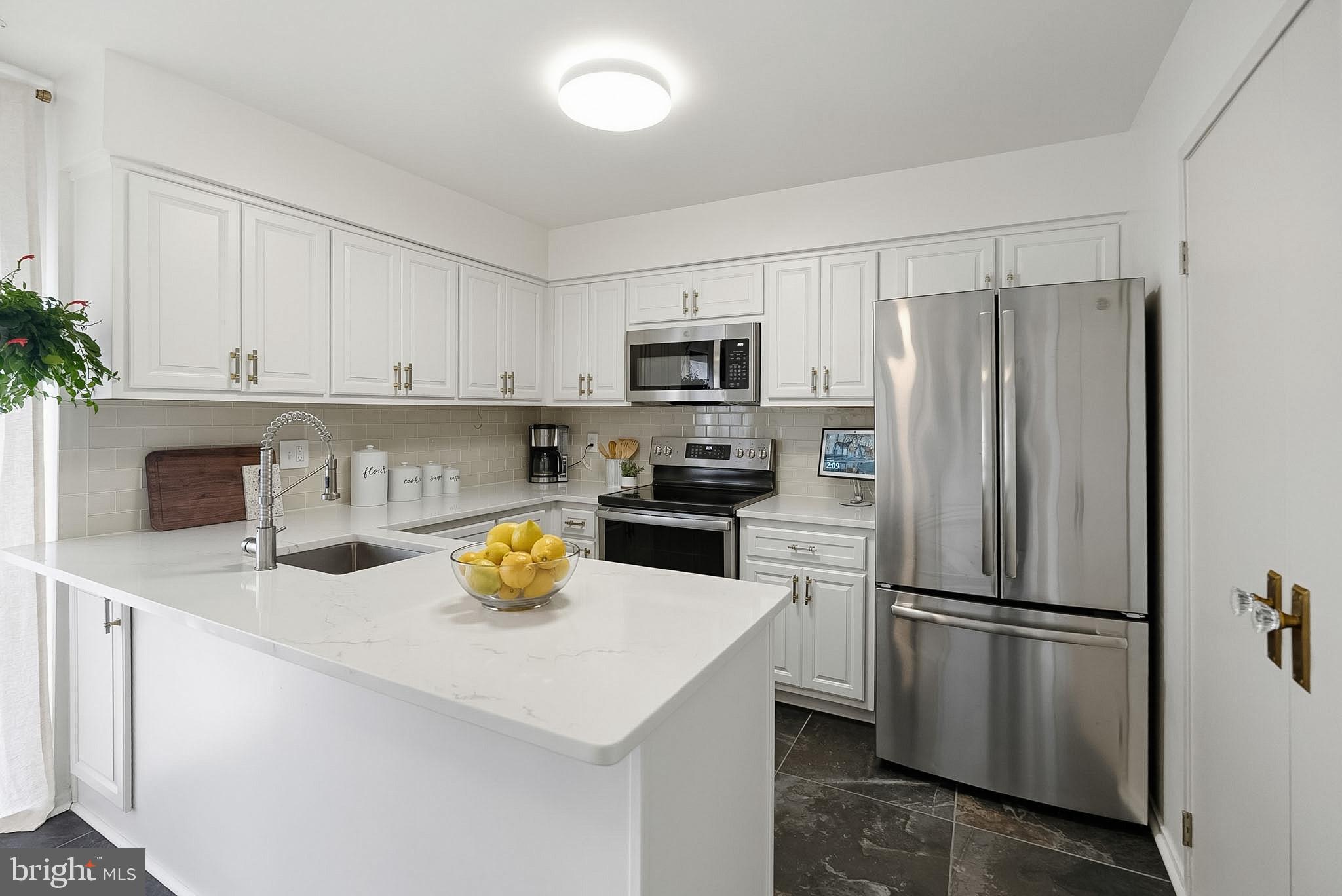9060 Blarney Stone Drive Springfield, VA 22152 - Photo 14 of 47 a kitchen with a refrigerator and a sink