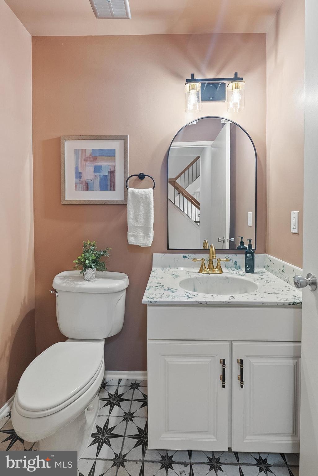 9060 Blarney Stone Drive Springfield, VA 22152 - Photo 18 of 47 a bathroom with a granite countertop toilet sink and mirror