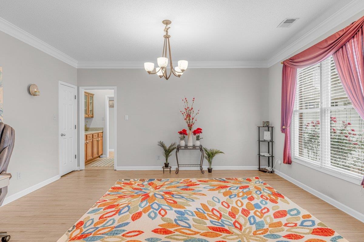 4840 Rainy Pass Road Collierville, TN 38017 - Photo 5 of 30 Spacious room featuring light wood-finish flooring, crown molding, and a five-light chandelier