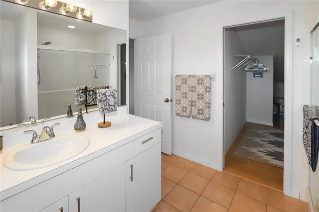 a bedroom with two beds and next to window