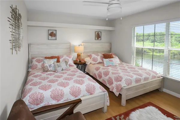 a bedroom with two beds and a couch