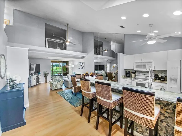 a kitchen with a table chairs stove and refrigerator
