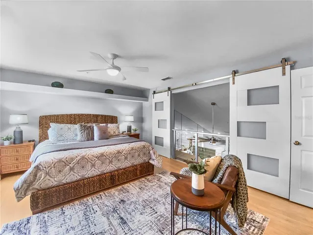 a bedroom with a large bed and a window