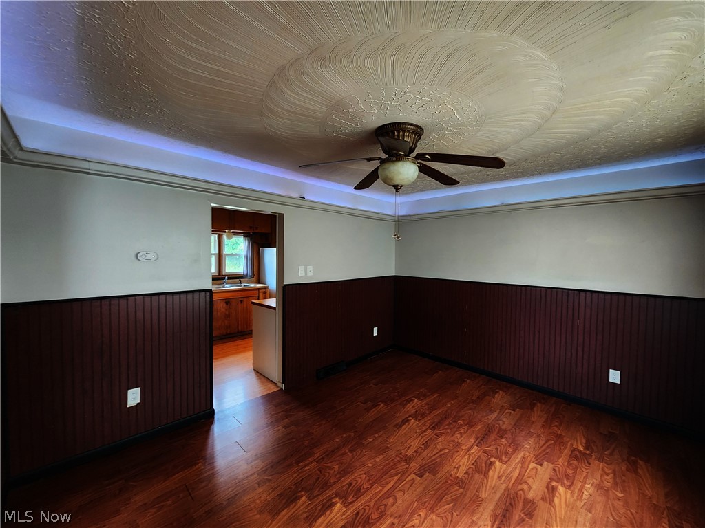 30 West Wilbeth Road, Unit A Akron, OH 44301 - Photo 5 of 16 Empty room featuring sink, ceiling fan, and dark wood-type flooring