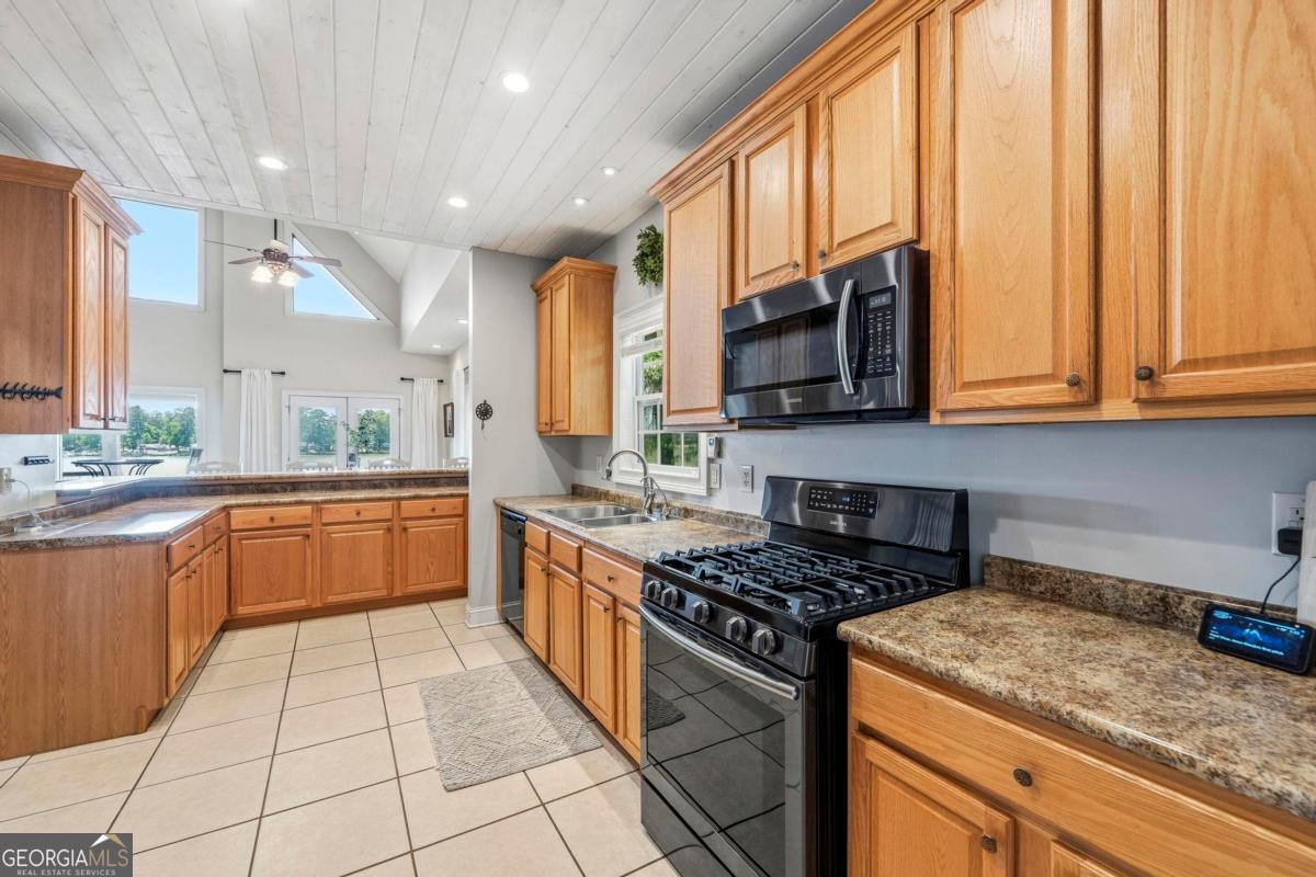 172 Mays Road Milledgeville, GA 31061 - Photo 20 of 54 a kitchen with stainless steel appliances granite countertop a stove a sink and a microwave