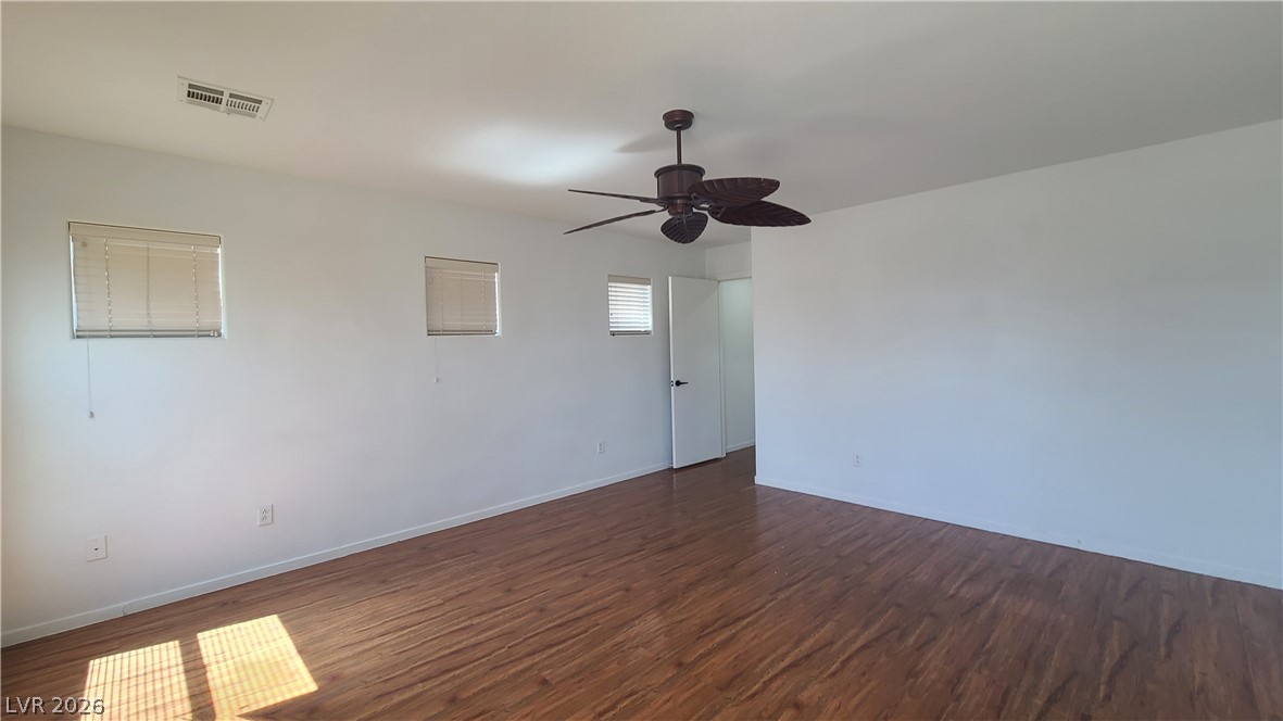 8944 Rutherford Grove Street Las Vegas, NV 89148 - Photo 16 of 35 A generous room featuring attractive wood-look flooring and a functional ceiling fan.