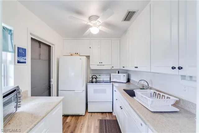 a kitchen with a sink a stove and refrigerator