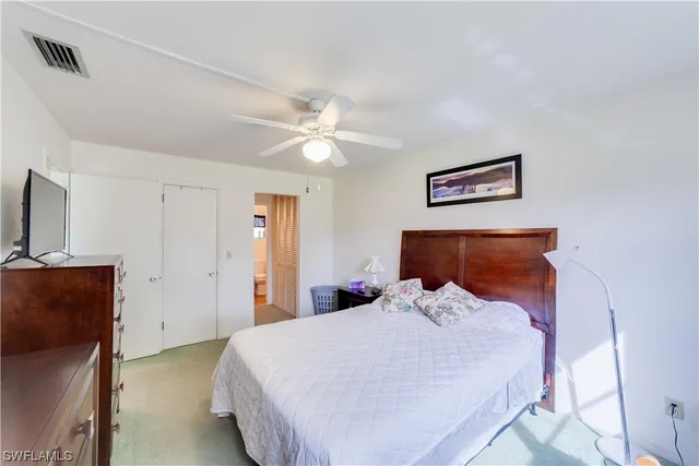 a bedroom with a bed and a couch