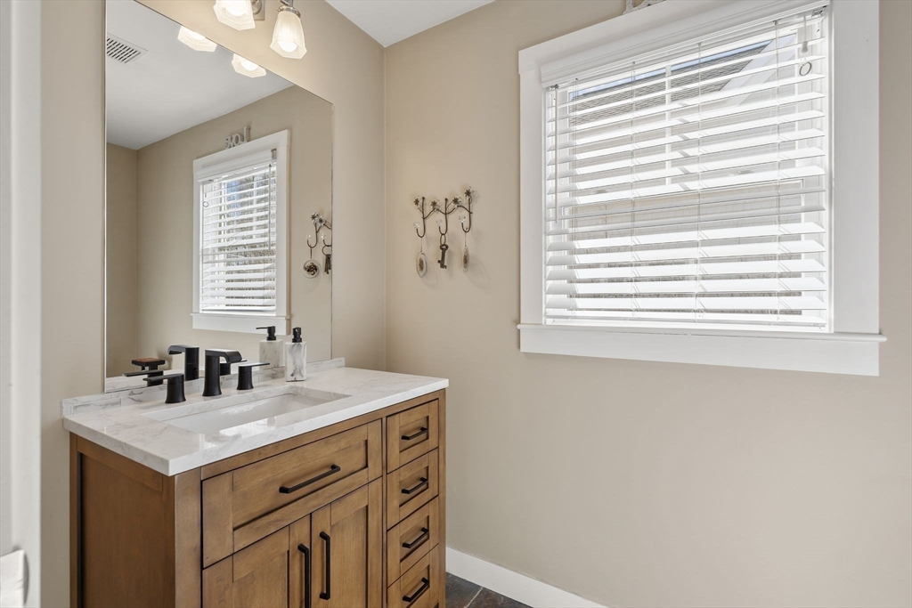 22 Pattison Road Webster, MA 01570 - Photo 13 of 42 a bathroom with a sink a vanity and a window