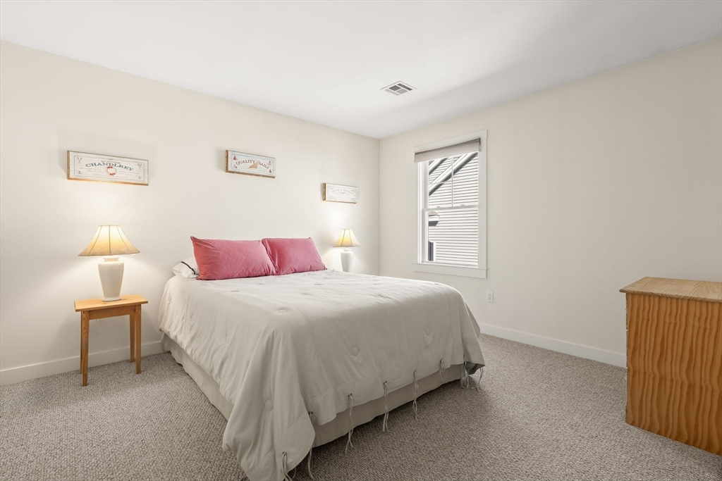 22 Pattison Road Webster, MA 01570 - Photo 23 of 42 a bedroom with a bed and a lamp