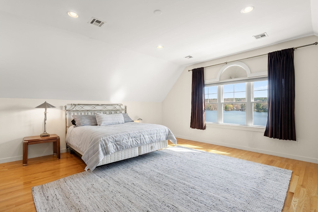 22 Pattison Road Webster, MA 01570 - Photo 27 of 42 a spacious bedroom with a large bed and a large window