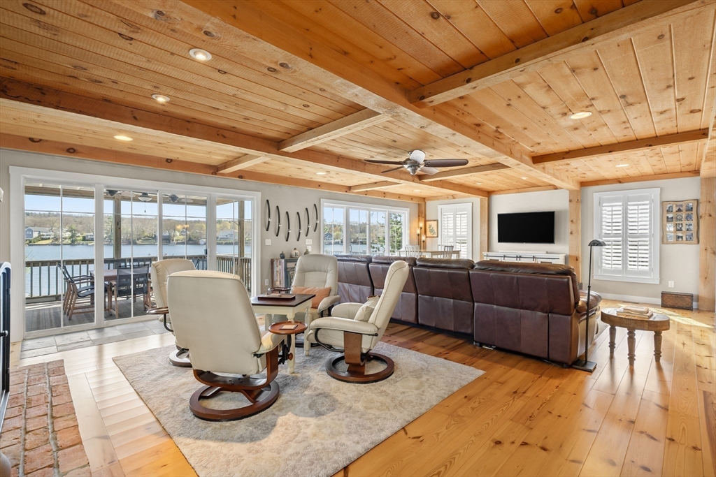 22 Pattison Road Webster, MA 01570 - Photo 6 of 42 a living room with furniture a flat screen tv and floor to ceiling window