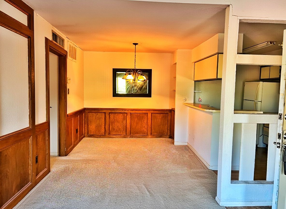 9000 Bissonnet Street, Unit 406 Houston, TX 77074 - Photo 6 of 8 a view of a hallway with paintings on the wall