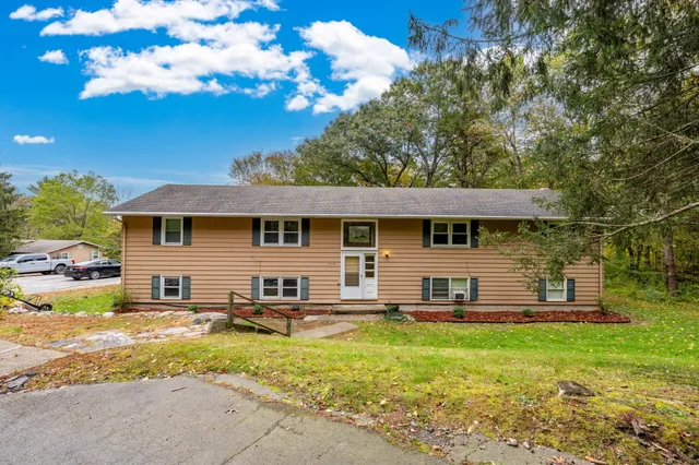 a view of a house with a backyard