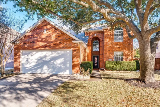 a view of a house with a tree in front