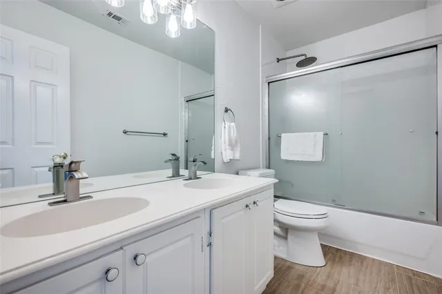 a bathroom with a sink toilet and a mirror