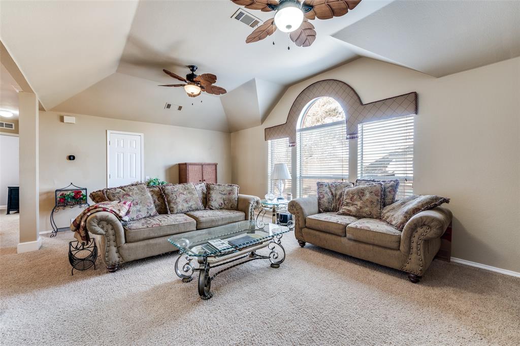 5904 Berkshire Road McKinney, TX 75072 - Photo 18 of 26 a living room with furniture a large window and a chandelier