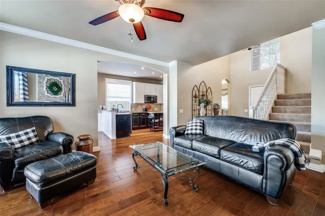 a living room with furniture and a wooden floor