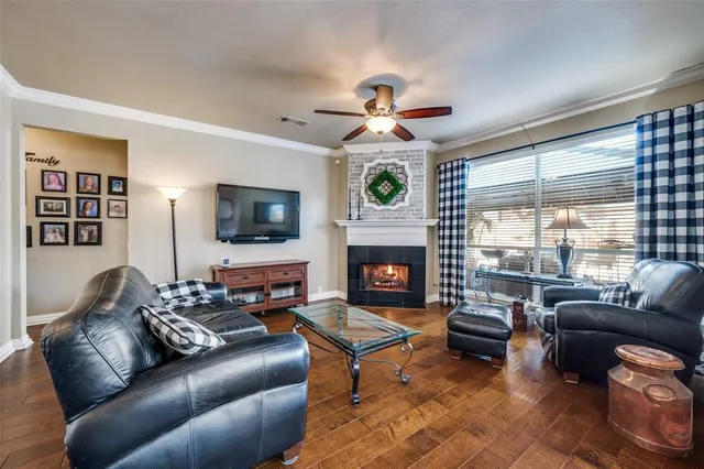 a living room with furniture a flat screen tv and a fireplace