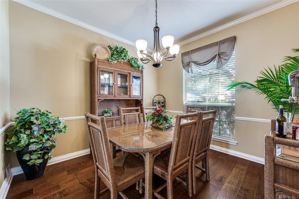 5904 Berkshire Road McKinney, TX 75072 - Photo 21 of 26 a dining room with furniture potted plants and wooden floor