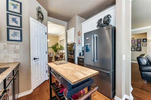 a kitchen with stainless steel appliances a refrigerator and a stove