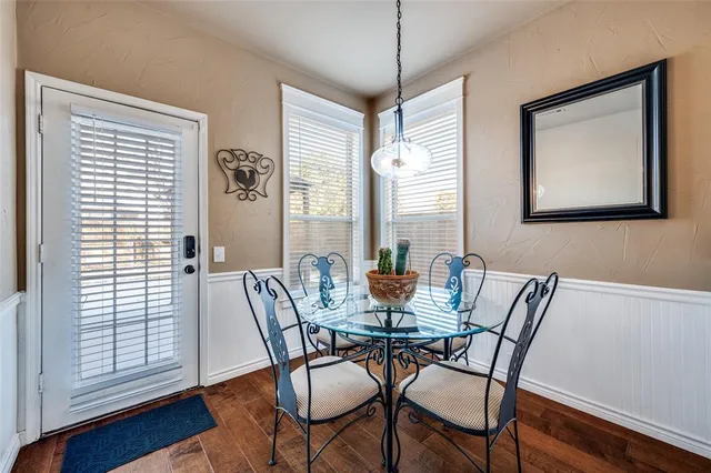 a view of a dining room with furniture window and wooden floor