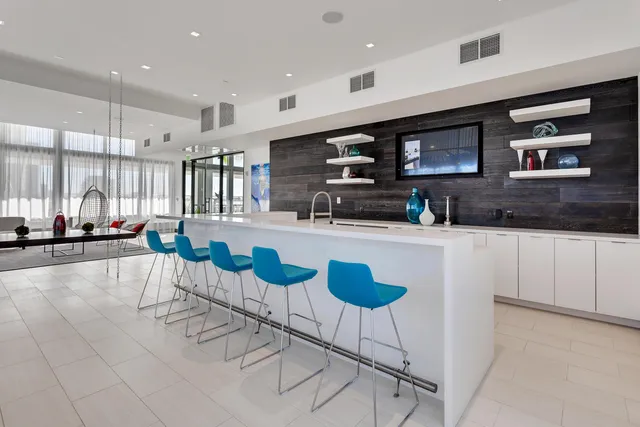 a large kitchen with stainless steel appliances kitchen island granite countertop a sink and cabinets