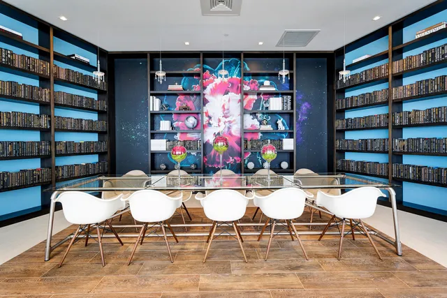 a view of a dining room with furniture and book shelf