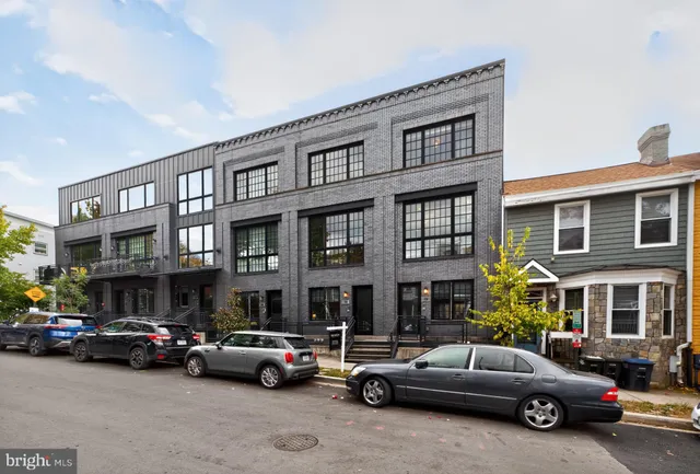 a view of a cars park in front of a building
