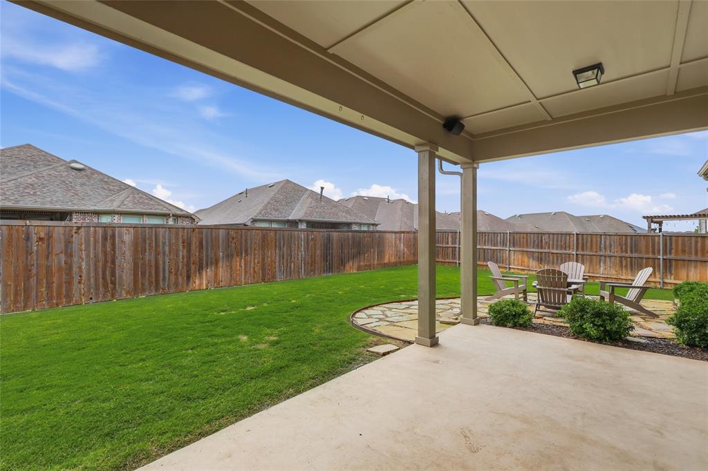 1701 Shetland Road Aubrey, TX 76227 - Photo 18 of 34 Covered patio with surround sound and an additional flagstone patio area for those nights by the fire!