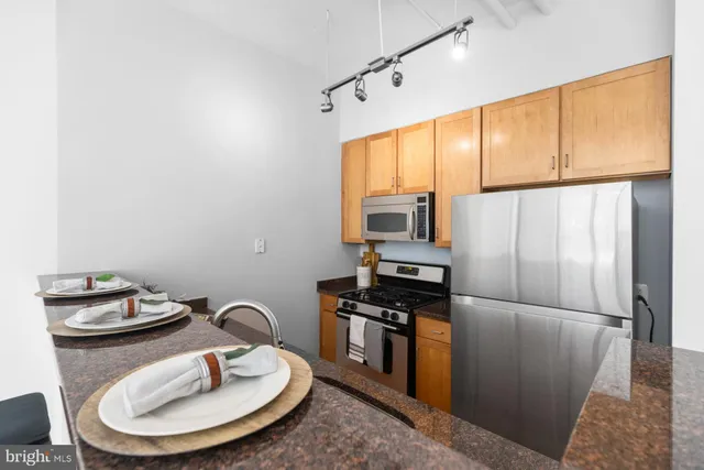 a kitchen with granite countertop a sink and cabinets