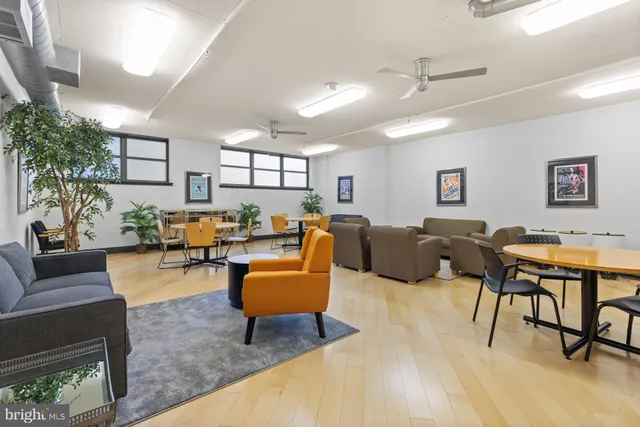 a living room with furniture kitchen view and a table
