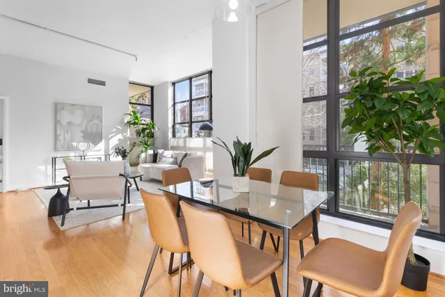 a dining room with furniture and wooden floor